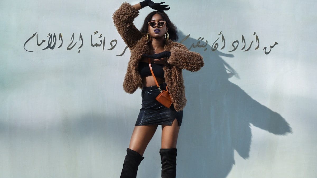woman in brown coat and black boots